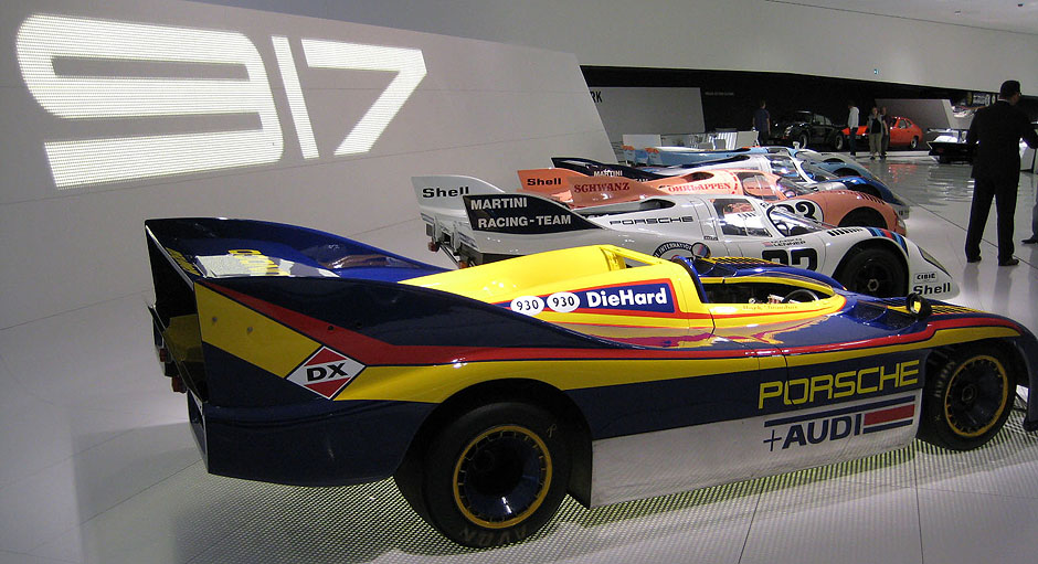 Fleet of the 917 racing cars. There were more than 10 versions of racing cars called 917. The one in front is 917/30, the most powerful Porsche ever produced and the most powerful race track car ever (5.4-litre 12-cyl. bi-turbo, ~1200 kW). It basically competed only one season (1973) as the fuel consumption limit was introduced after they saw this beast.