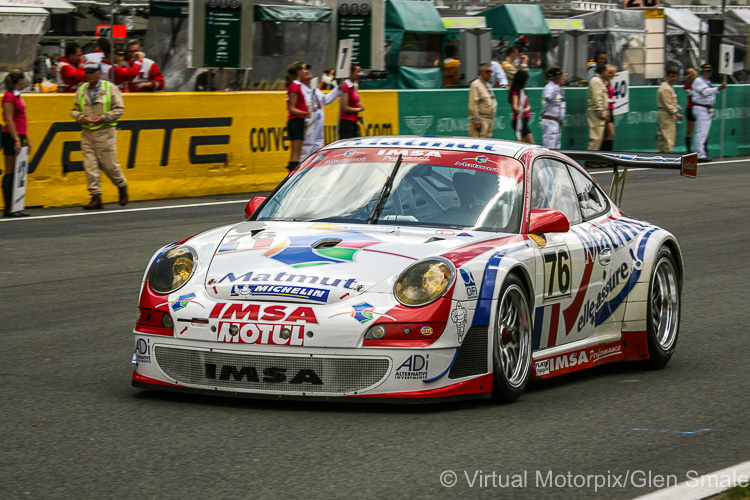 The #76 IMSA Performance Matmut Porsche 911 GT3 RSR pulls away from the pit wall at the start of the warm-up lap driven by Patrick Long