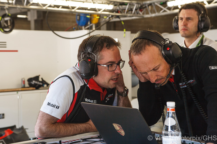 Pascal Zurlinden talks to a team member during the race