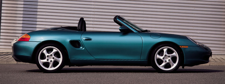 Green metallic Porsche Boxster 986, side view