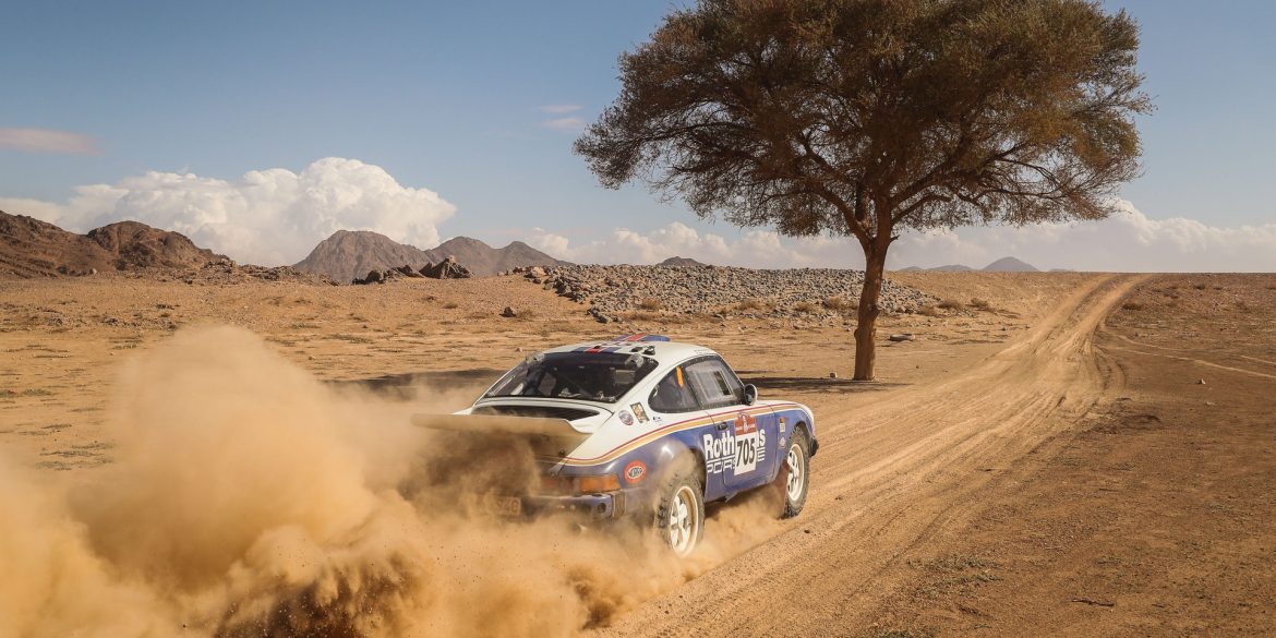 Amy Lerner's 1982 Porsche 911 SC racing through desert during 2022 Dakar Classic