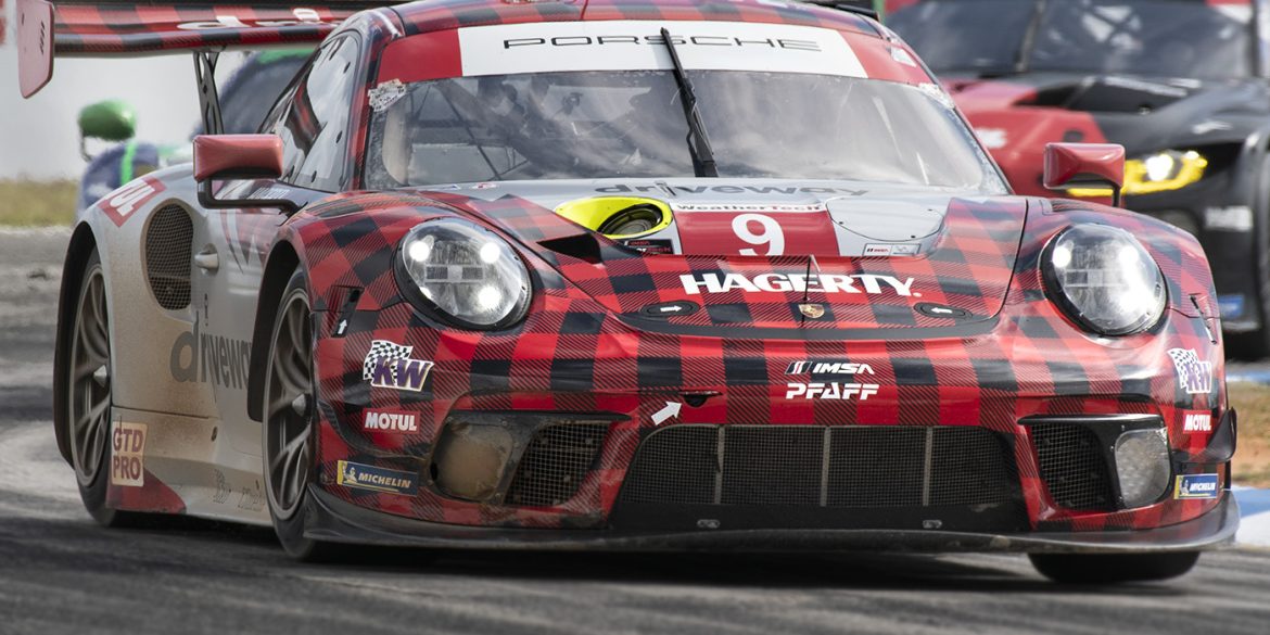Porsche in red and black plaid livery on track at Sebring 2022