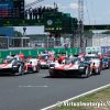 The No. 8 Toyota (closest to the camera) leads the Hypercar class across the start line