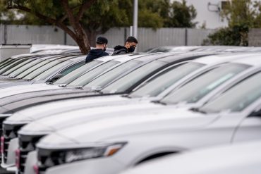 two buyers at a car lot