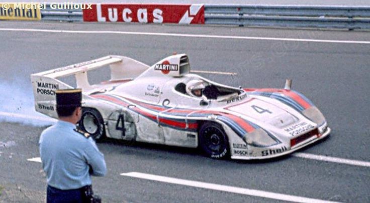 #4 936/77 trailing smoke as it heads down the pit lane at le Circuit de la Sarthe