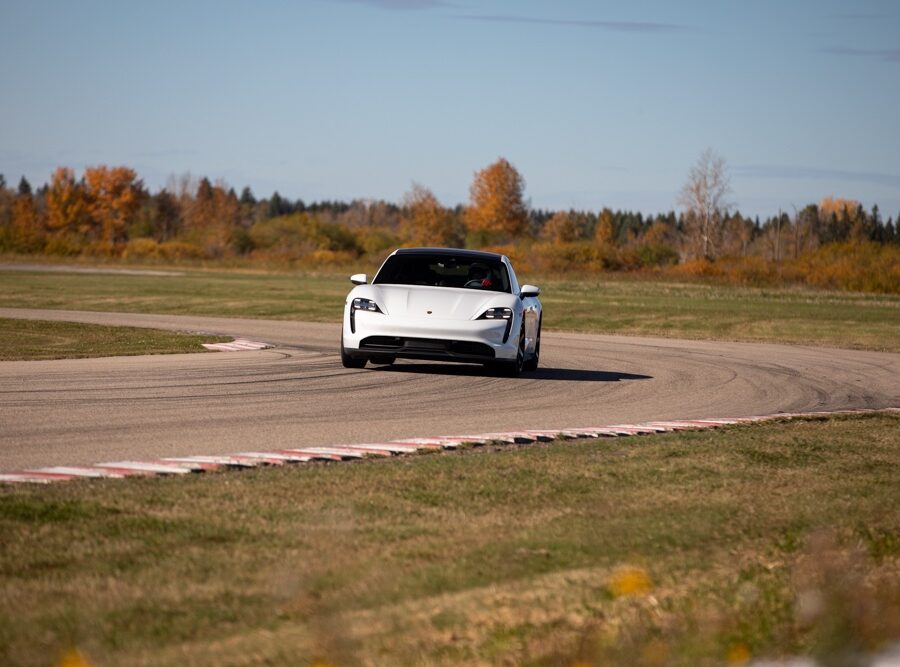 Porsche EV driving around curve on racetrack